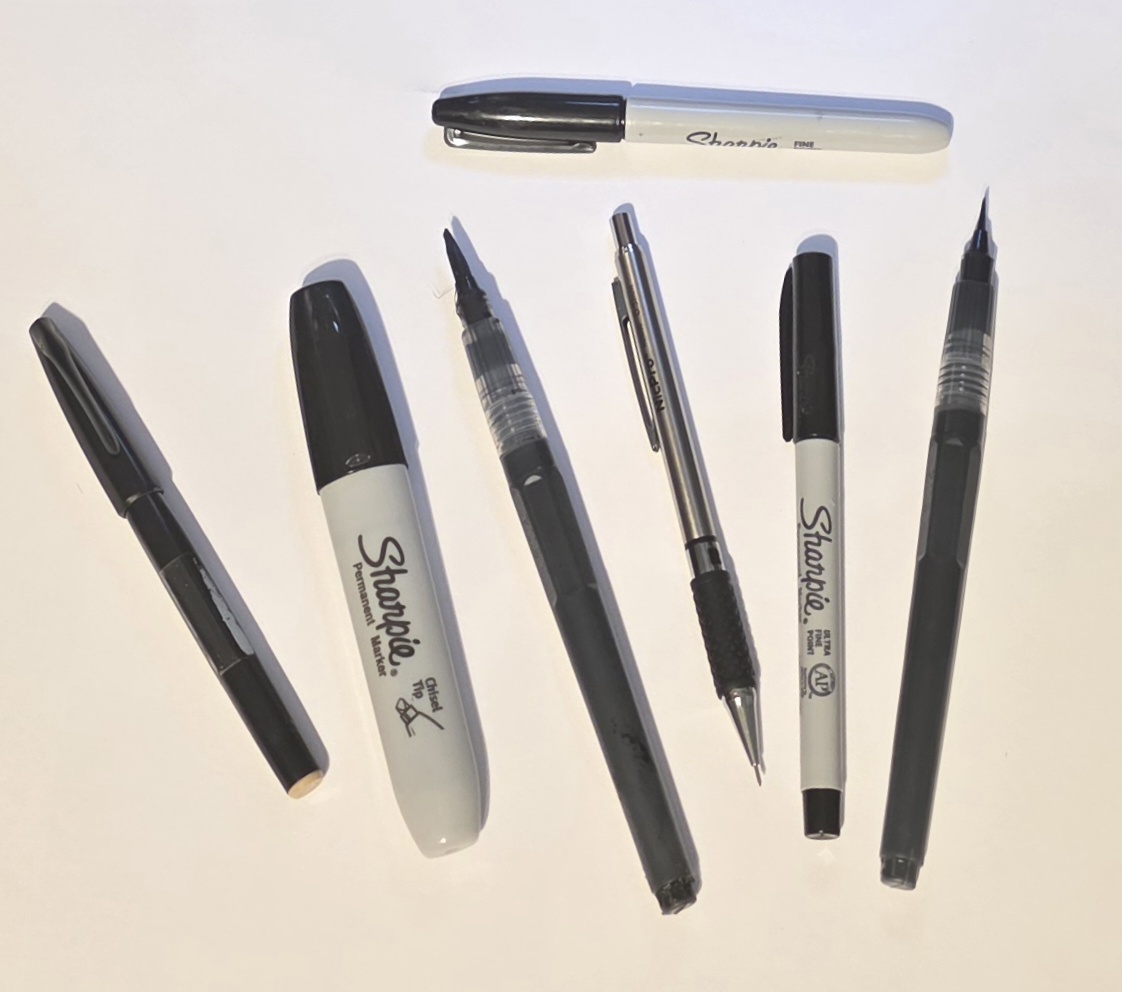 Art supplies including Sharpie and Pentel markers, Sumi ink, and Ohuhu brush pens